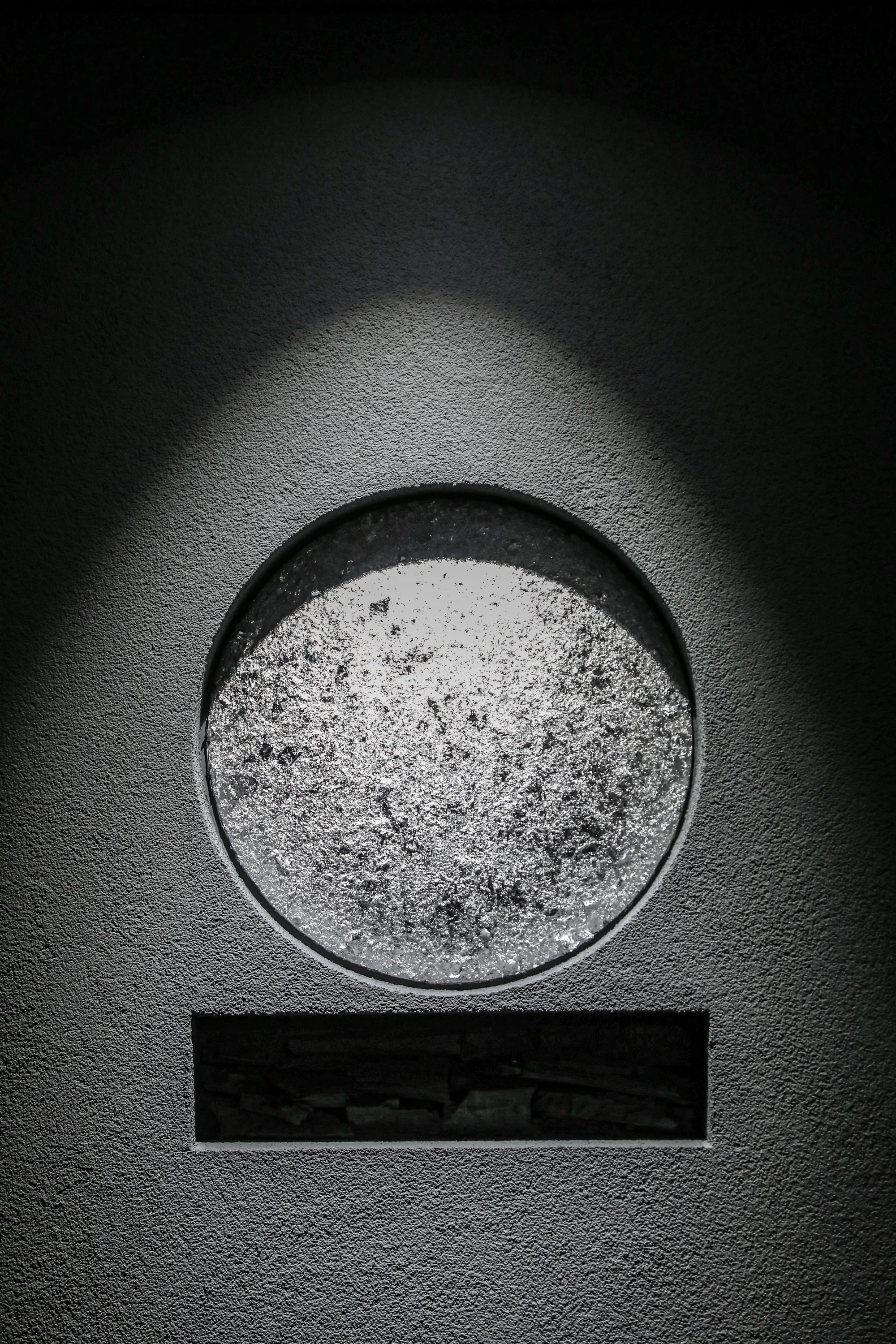 Moon and charcoal emblem on the entrance wall